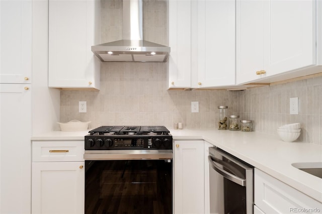 2257 S Lowell Blvd, Denver, CO 80219 - kitchen with black range with gas stovetop, wall chimney exhaust hood, stainless steel dishwasher, white cabinetry, and light countertops