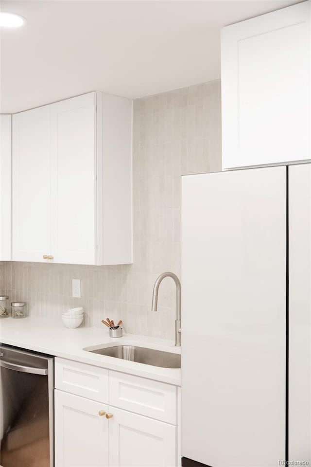 2257 S Lowell Blvd, Denver, CO 80219 - kitchen featuring dishwasher, light countertops, white cabinets, and decorative backsplash
