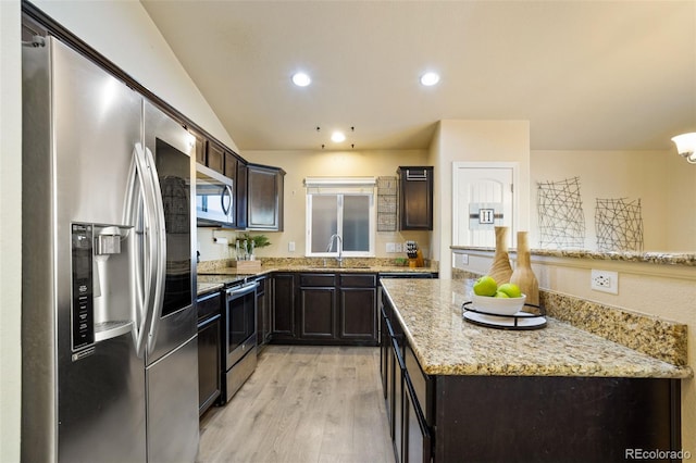 kitchen with light stone countertops, sink, stainless steel appliances, light hardwood / wood-style flooring, and vaulted ceiling