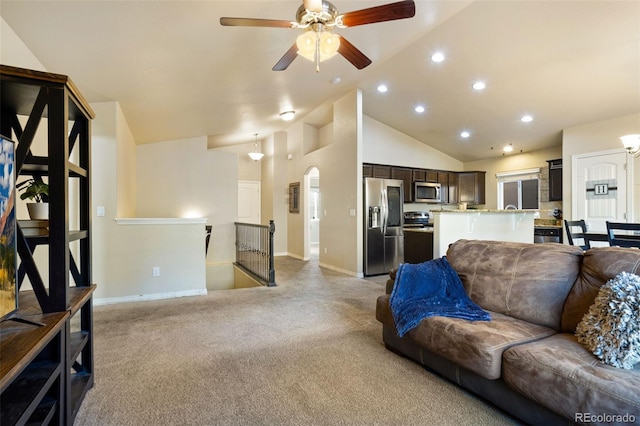 carpeted living room featuring high vaulted ceiling and ceiling fan