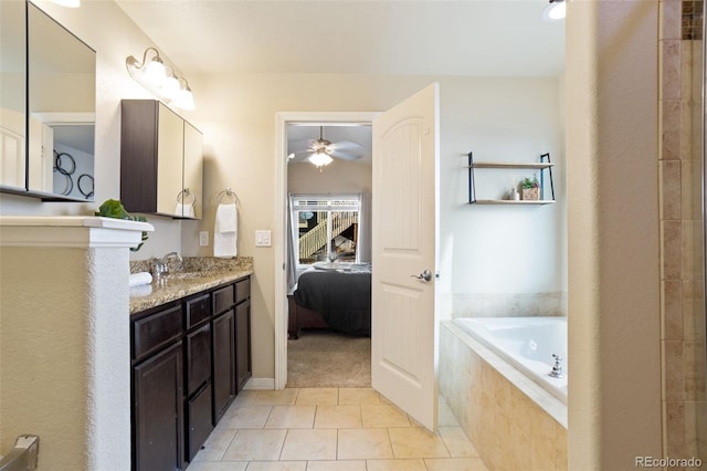 bathroom featuring vanity, tile patterned floors, ceiling fan, and tiled tub