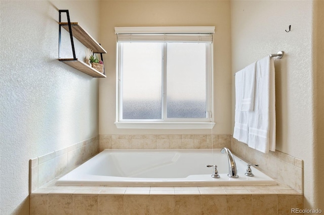 bathroom with a relaxing tiled tub