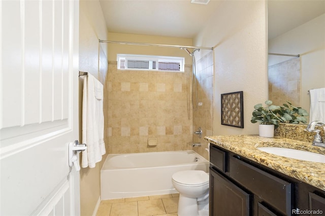 full bathroom with tile patterned flooring, vanity, tiled shower / bath combo, and toilet