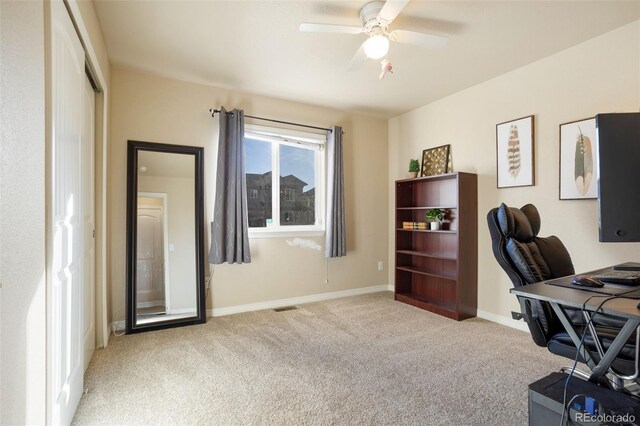 office space featuring ceiling fan and light colored carpet