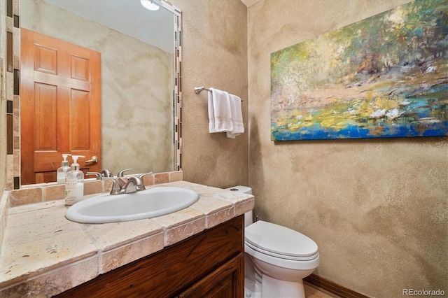 bathroom featuring toilet and vanity