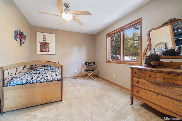 bedroom featuring light colored carpet, ceiling fan, and baseboards