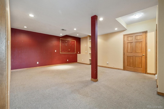 finished below grade area featuring carpet floors, baseboards, visible vents, and recessed lighting