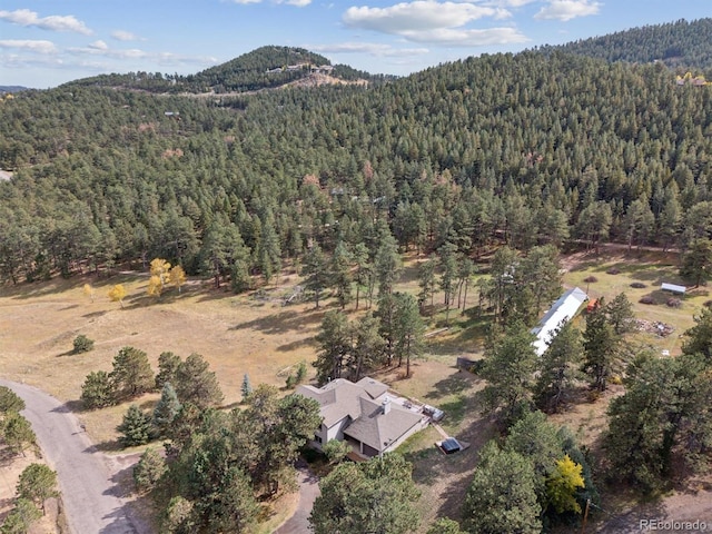 aerial view featuring a forest view and a mountain view