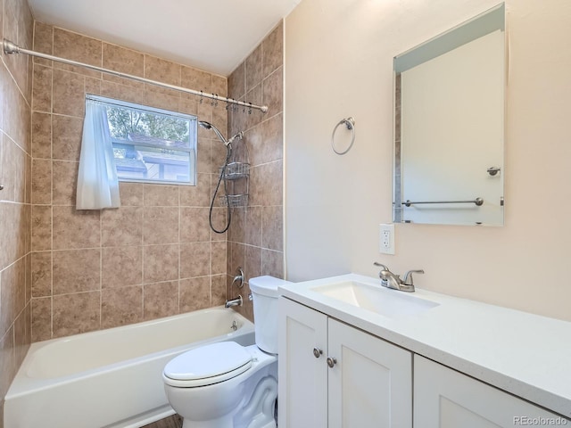 full bathroom featuring tiled shower / bath combo, toilet, and vanity