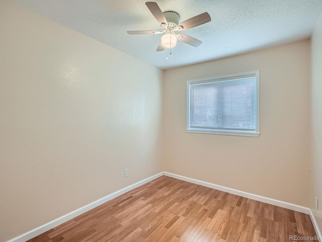 spare room with ceiling fan, a textured ceiling, and light hardwood / wood-style flooring