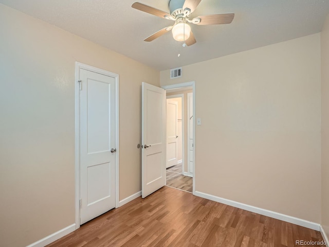 unfurnished bedroom featuring ceiling fan and light wood-type flooring