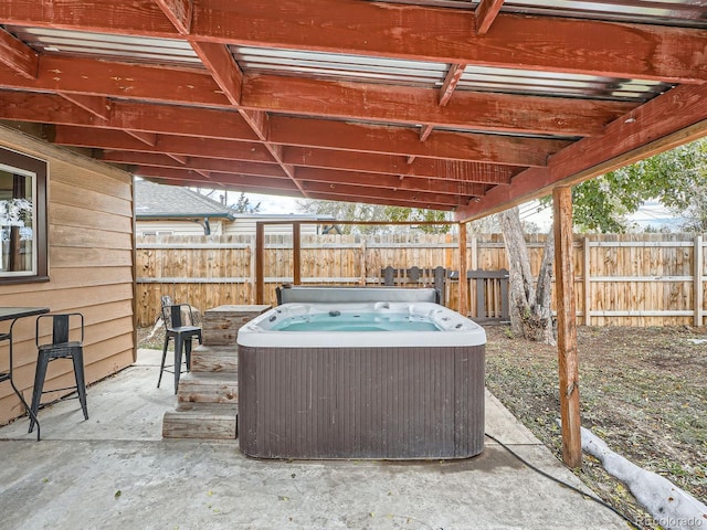 view of patio / terrace with a hot tub