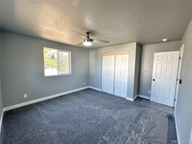 unfurnished bedroom with ceiling fan, visible vents, baseboards, a closet, and dark carpet