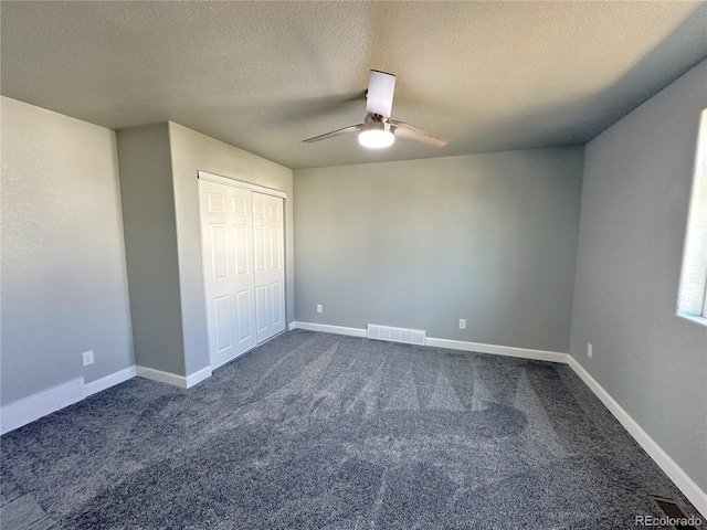 unfurnished bedroom featuring dark colored carpet, visible vents, and baseboards