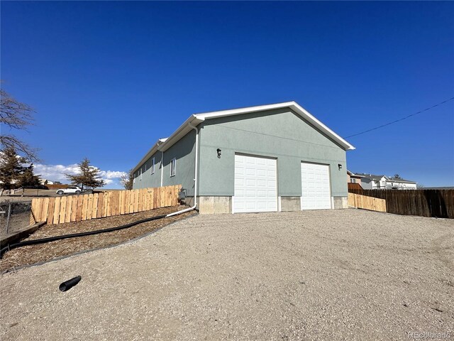 exterior space featuring fence and driveway