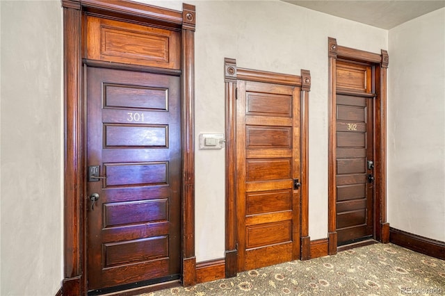 foyer entrance featuring carpet floors