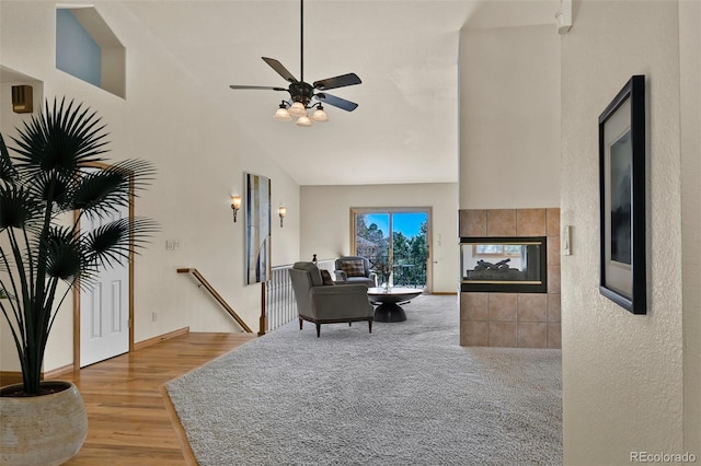5130 Sevenoaks Dr, Colorado Springs, CO 80919 - living area featuring a fireplace, a ceiling fan, high vaulted ceiling, and light wood finished floors