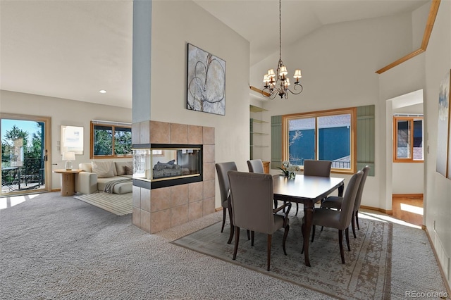 5130 Sevenoaks Dr, Colorado Springs, CO 80919 - carpeted dining area with recessed lighting, an inviting chandelier, high vaulted ceiling, baseboards, and a fireplace