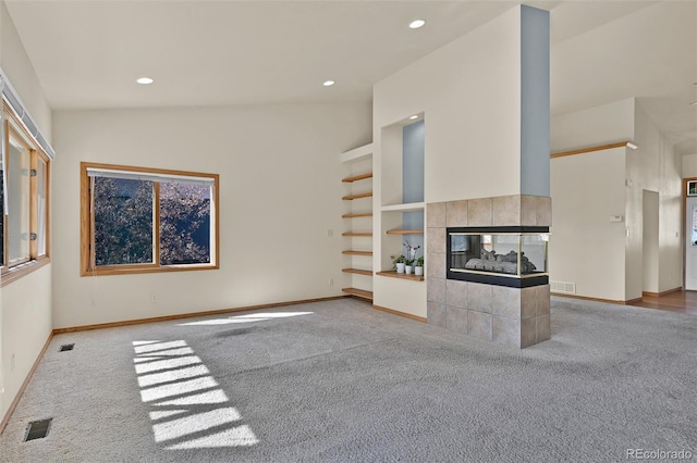 5130 Sevenoaks Dr, Colorado Springs, CO 80919 - unfurnished living room with a tiled fireplace, built in features, carpet, and visible vents