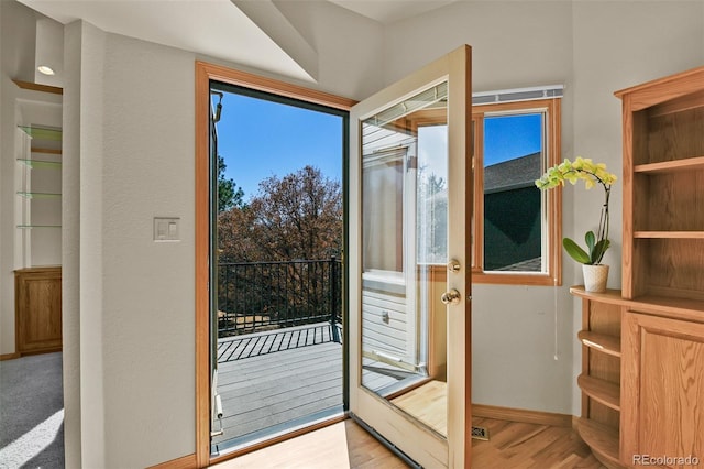 5130 Sevenoaks Dr, Colorado Springs, CO 80919 - doorway to outside featuring baseboards and light wood-style flooring