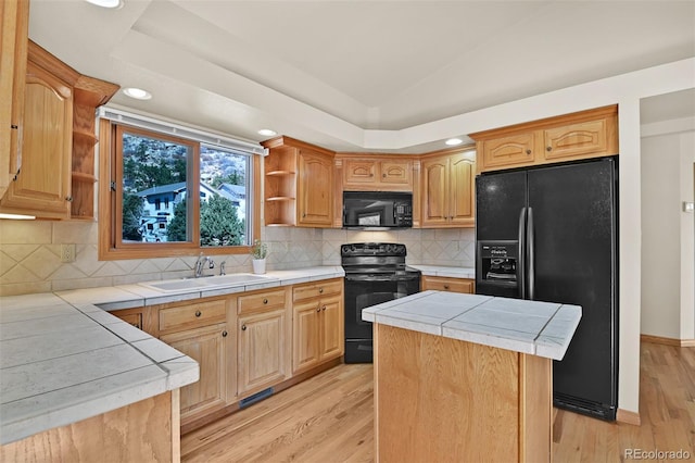 5130 Sevenoaks Dr, Colorado Springs, CO 80919 - kitchen with a sink, tile countertops, black appliances, and open shelves