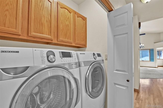 5130 Sevenoaks Dr, Colorado Springs, CO 80919 - clothes washing area featuring separate washer and dryer, wood finished floors, and cabinet space