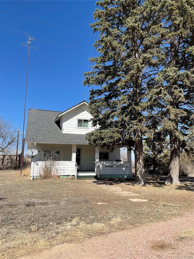 view of front of house with a porch and a shingled roof