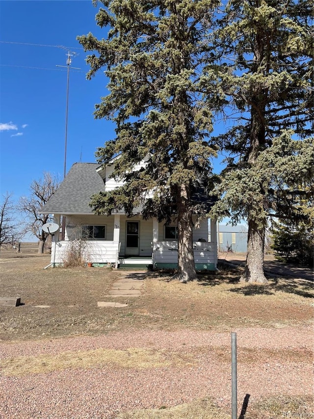 view of front of property with covered porch and a shingled roof