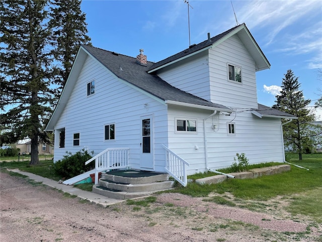 117 Lincoln Ave, Arriba, CO 80804 - rear view of property with a chimney and roof with shingles