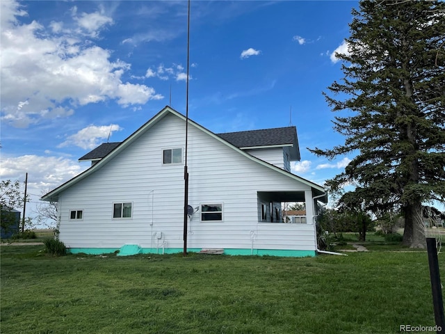 117 Lincoln Ave, Arriba, CO 80804 - view of home's exterior with a lawn and roof with shingles