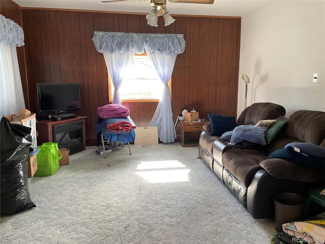 117 Lincoln Ave, Arriba, CO 80804 - carpeted living room featuring a ceiling fan and wooden walls