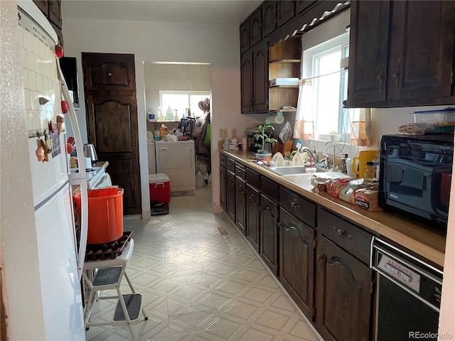 117 Lincoln Ave, Arriba, CO 80804 - kitchen featuring washing machine and clothes dryer, a sink, light flooring, dark brown cabinetry, and black appliances