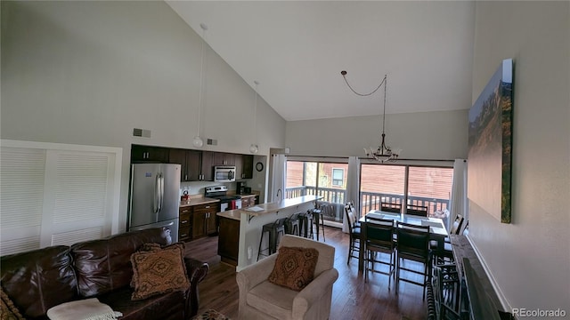 2710 Ryan Gulch Rd Unit 2731, Silverthorne, CO 80498 - kitchen with appliances with stainless steel finishes, high vaulted ceiling, dark wood finished floors, a chandelier, and light countertops