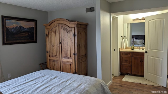 2710 Ryan Gulch Rd Unit 2731, Silverthorne, CO 80498 - bedroom with wood finished floors, a sink, ensuite bath, and baseboards