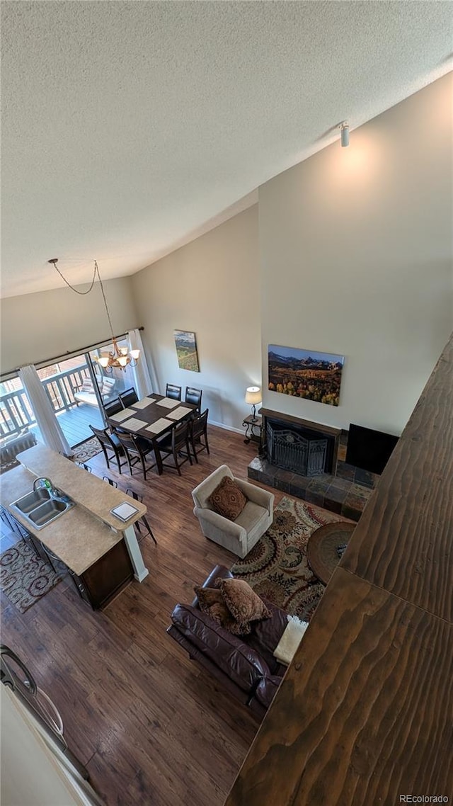 2710 Ryan Gulch Rd Unit 2731, Silverthorne, CO 80498 - living area with a textured ceiling, wood finished floors, and a chandelier