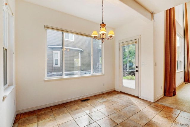 unfurnished dining area featuring light tile patterned floors and a notable chandelier