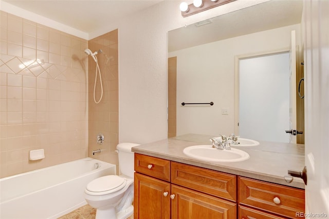 full bathroom with vanity, toilet, and tiled shower / bath