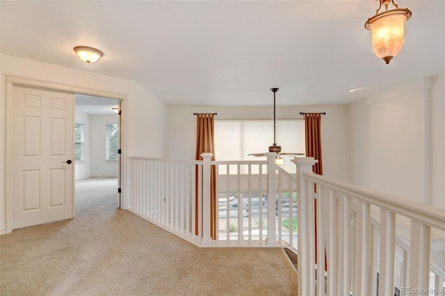 hallway featuring light carpet