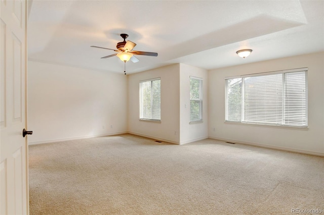 empty room featuring ceiling fan and light colored carpet