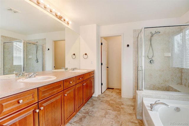 bathroom with independent shower and bath and vanity