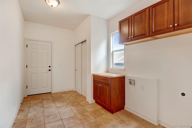 washroom featuring hookup for a washing machine, cabinets, and hookup for an electric dryer