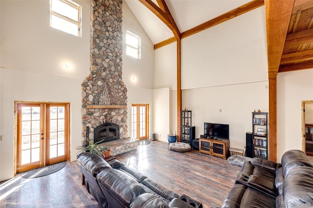 2710 Rustlers Canyon Loop, Elizabeth, CO 80107 - living room with high vaulted ceiling, french doors, wood finished floors, plenty of natural light, and beam ceiling