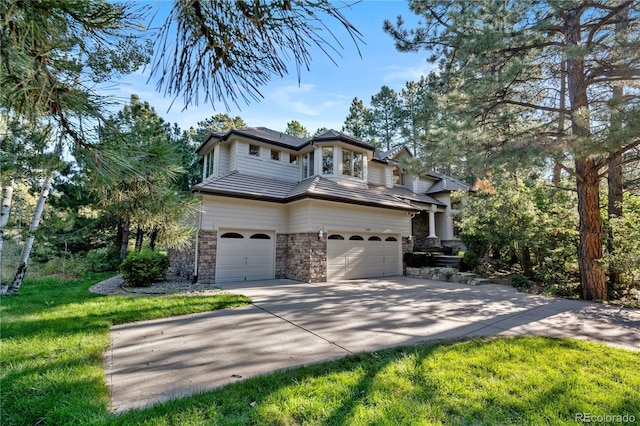 view of front of home featuring a garage and a front lawn