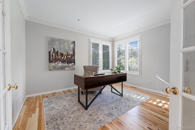 home office featuring crown molding and light hardwood / wood-style floors