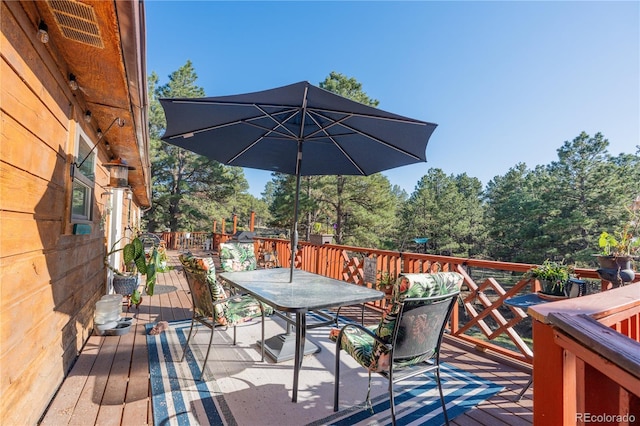 wooden deck featuring outdoor dining space