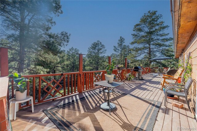 wooden terrace featuring area for grilling