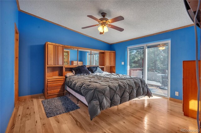 bedroom featuring wood finished floors, a textured ceiling, lofted ceiling, ornamental molding, and access to exterior