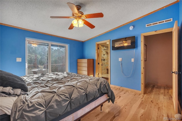 bedroom featuring lofted ceiling, visible vents, ornamental molding, wood-type flooring, and a textured ceiling