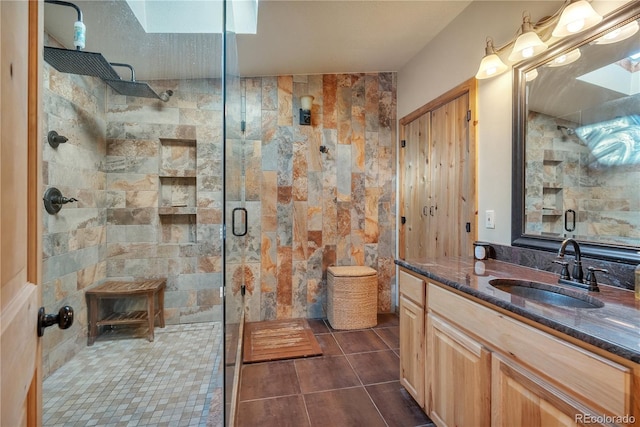 full bathroom featuring tile patterned flooring, vanity, and a stall shower