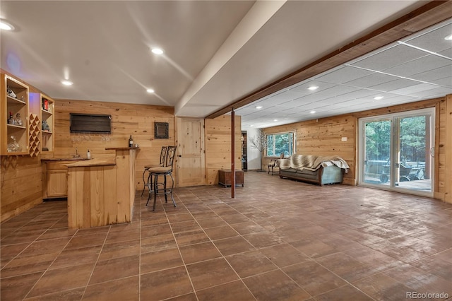 bar with recessed lighting and wood walls